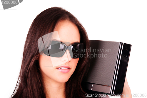 Image of Pretty girl listening with modern stereo