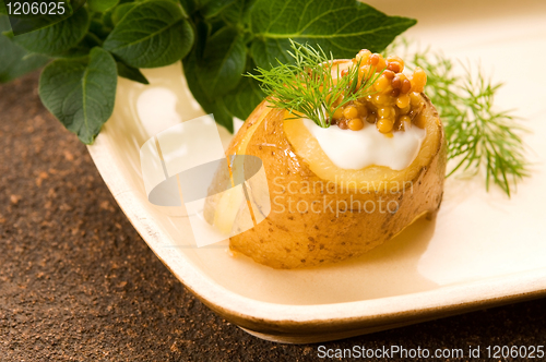 Image of Baked potato with sour cream, grain Dijon mustard and herbs