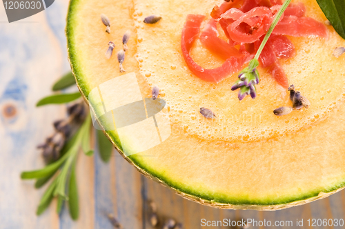 Image of fresh melon soup with parma ham and lavender flower