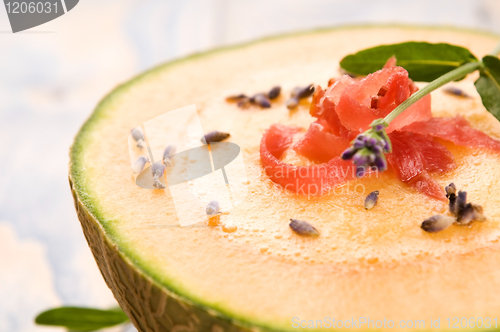 Image of fresh melon soup with parma ham and lavender flower