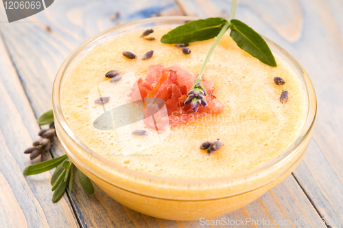 Image of fresh melon soup with parma ham and lavender flower