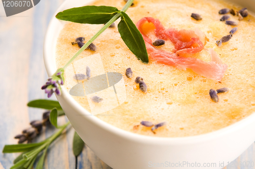 Image of fresh melon soup with parma ham and lavender flower