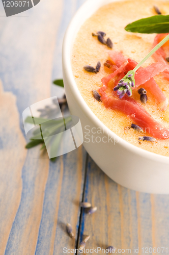 Image of fresh melon soup with parma ham and lavender flower