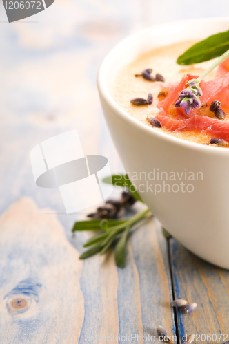 Image of fresh melon soup with parma ham and lavender flower