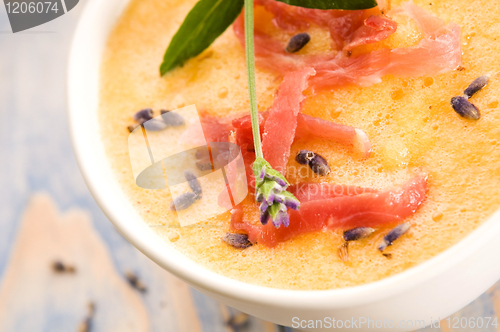 Image of fresh melon soup with parma ham and lavender flower