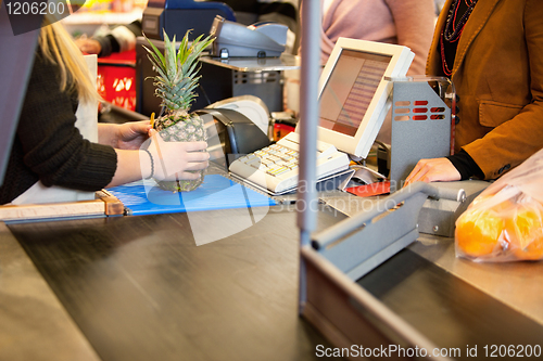 Image of Midsection of shop assistant and customer