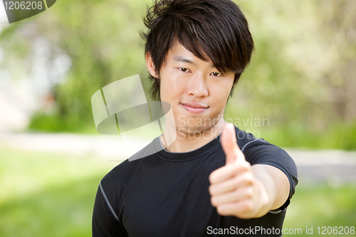 Image of Portrait of a man showing thumbs-up sign