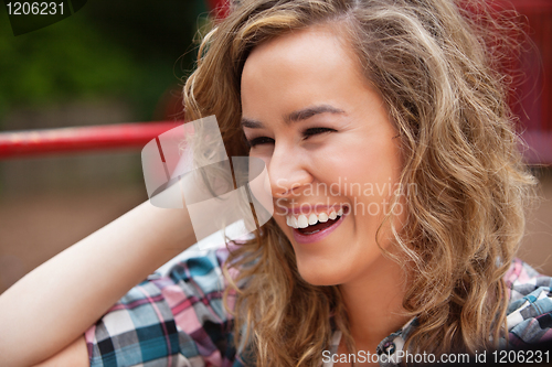 Image of Cheerful young woman laughing