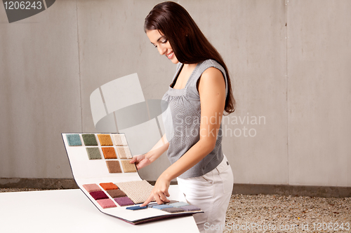 Image of Interior Architect Choosing Rug Sample