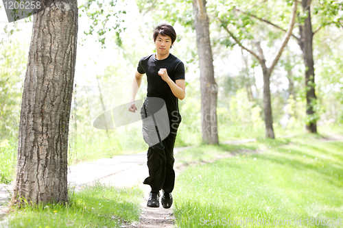 Image of Portrait of man running in a park