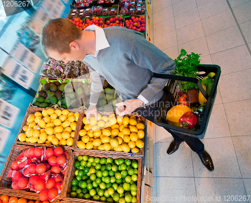 Image of Male in Supermarket Buying Fruit