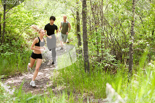 Image of Friends running in the forest