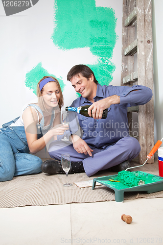 Image of Happy mature couple having champagne