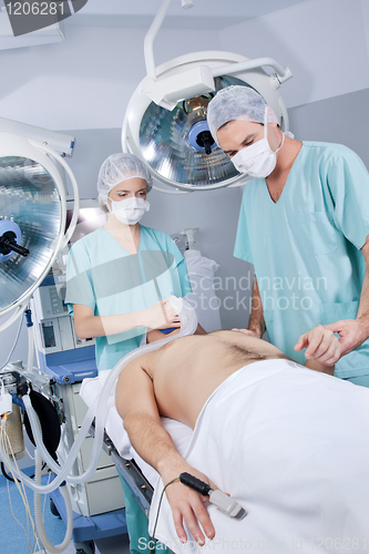 Image of Doctor and nurse preparing the patient for operation