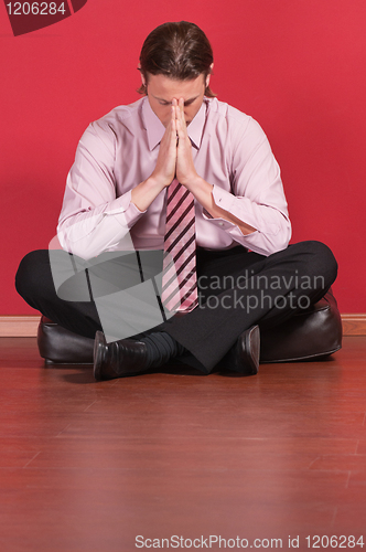 Image of Business executive sitting on the floor