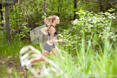 Image of Woman running in the forest