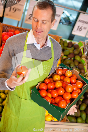 Image of Grocery Store Clerk with Tomatoes