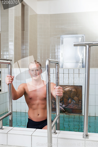 Image of Mature man stepping out of the pool