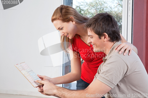 Image of Happy mature couple going through the color swatch