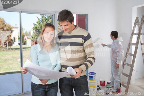 Image of Couple going through house plan