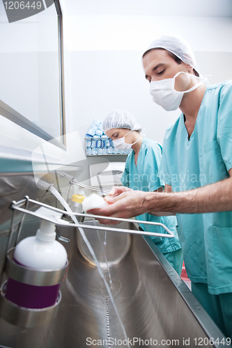 Image of Man and woman washing hands