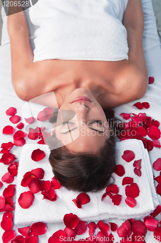 Image of Relaxed woman lying on a massage table