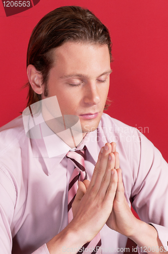 Image of Closeup of a businessman in prayer posture