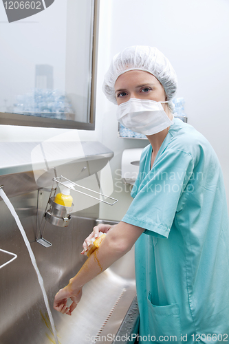 Image of Medical woman in mask washing hands