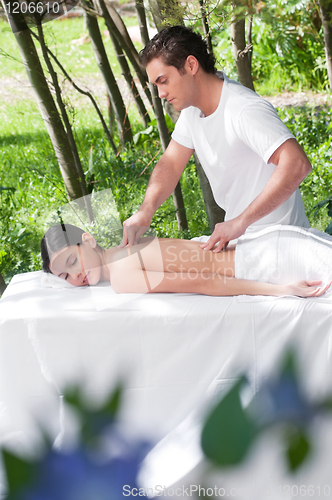 Image of Beautiful woman getting massage from a therapist