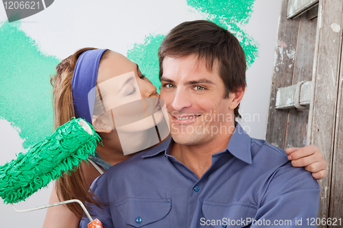 Image of Woman kissing her boyfriend on the cheek