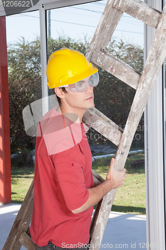 Image of Male construction worker with a ladder