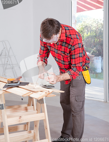 Image of Man Using Electric Hand Sander