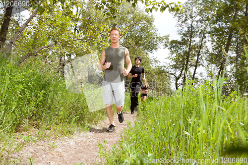 Image of Friends exercising in forest track