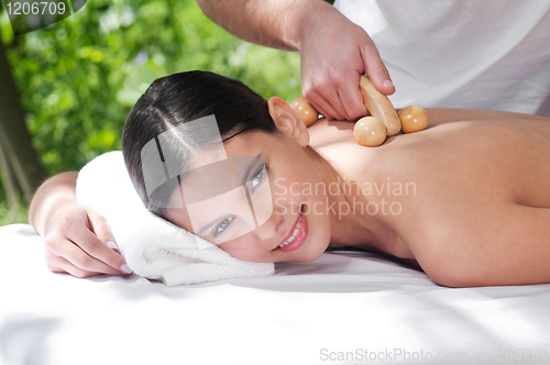 Image of Young woman getting massage by a therapist