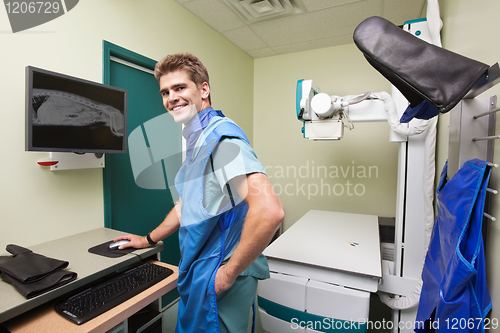 Image of Radiologist examining  X-ray of dog's spine