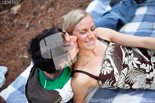 Image of Romantic young guy kissing happy female