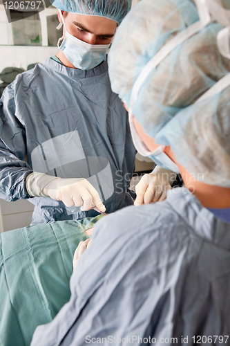 Image of Surgeons operating on patient