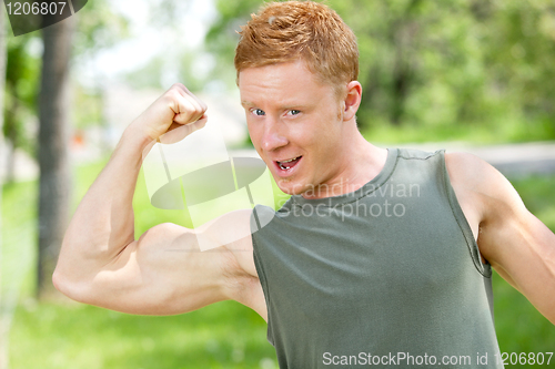 Image of Muscular man showing his biceps