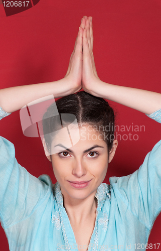 Image of Young pretty woman doing yoga exercise