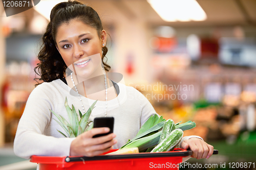 Image of Woman with Shopping List on Phone