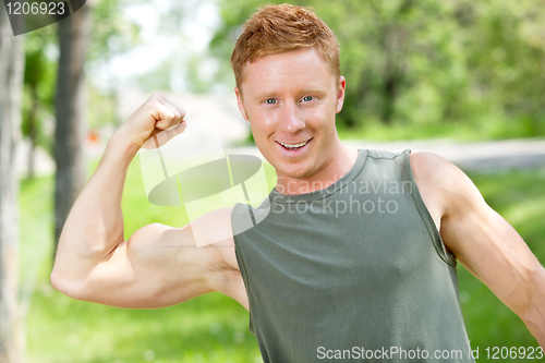 Image of Athletic man showing muscles