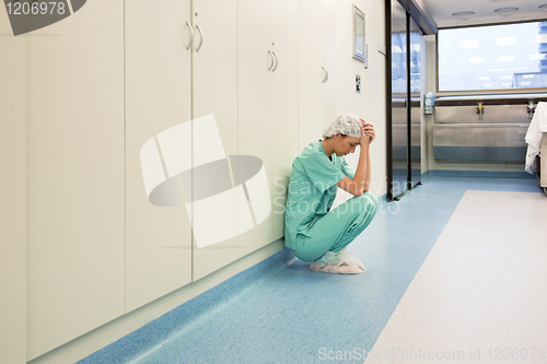 Image of Upset surgeon sitting alone