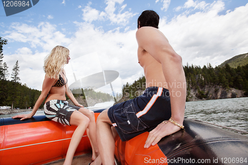 Image of Young couple in raft looking at view