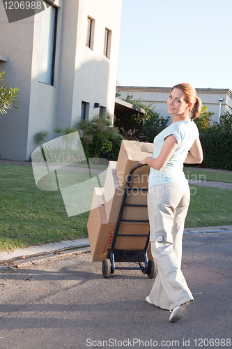 Image of Pretty woman moving to a new house