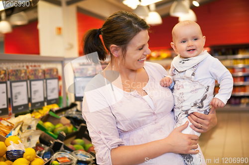 Image of Happy mother carrying child