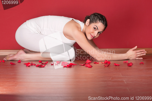 Image of Beautiful young woman in a yoga pose