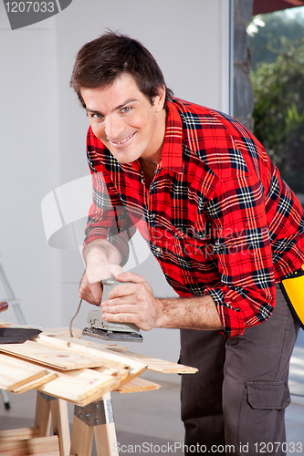 Image of Man with Electric Hand Sander