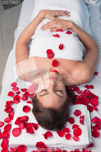 Image of Beautiful relaxed woman lying on a massage table