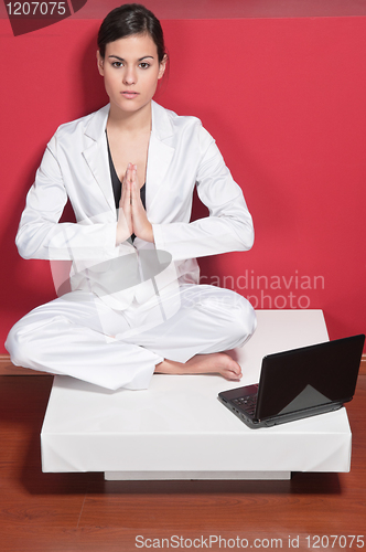 Image of Businesswoman doing yoga