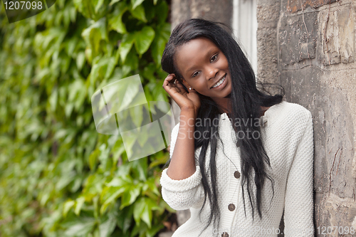 Image of Young African American woman standing and smiling